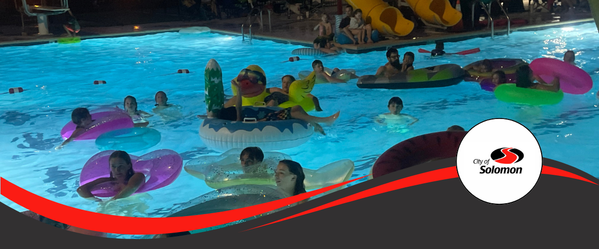 2024 Dive In Movie Night - guests float in floaties in pool