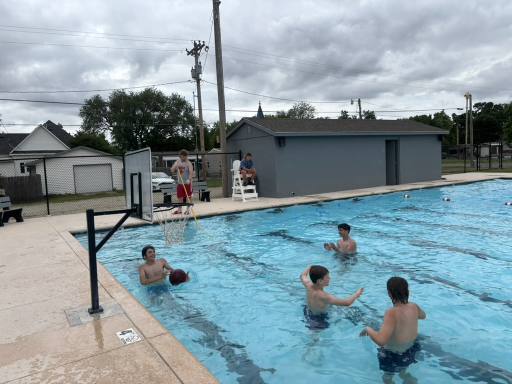 group of boys shooting hoops at pool