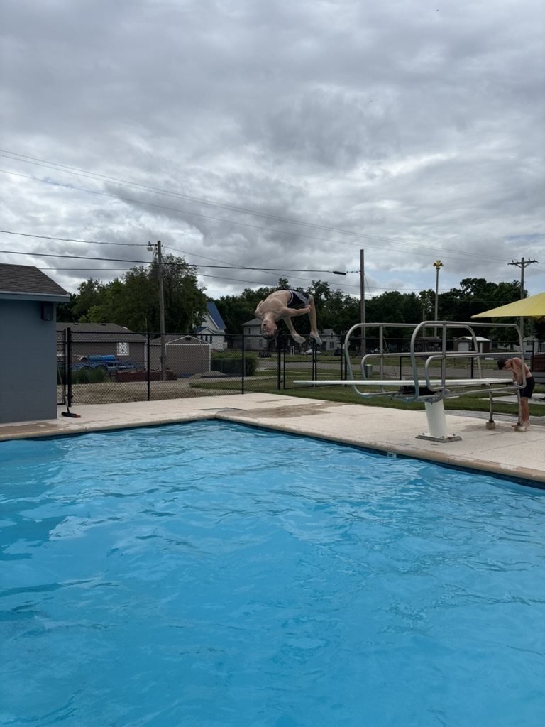 youth-doing-back-flip-off-diving-board